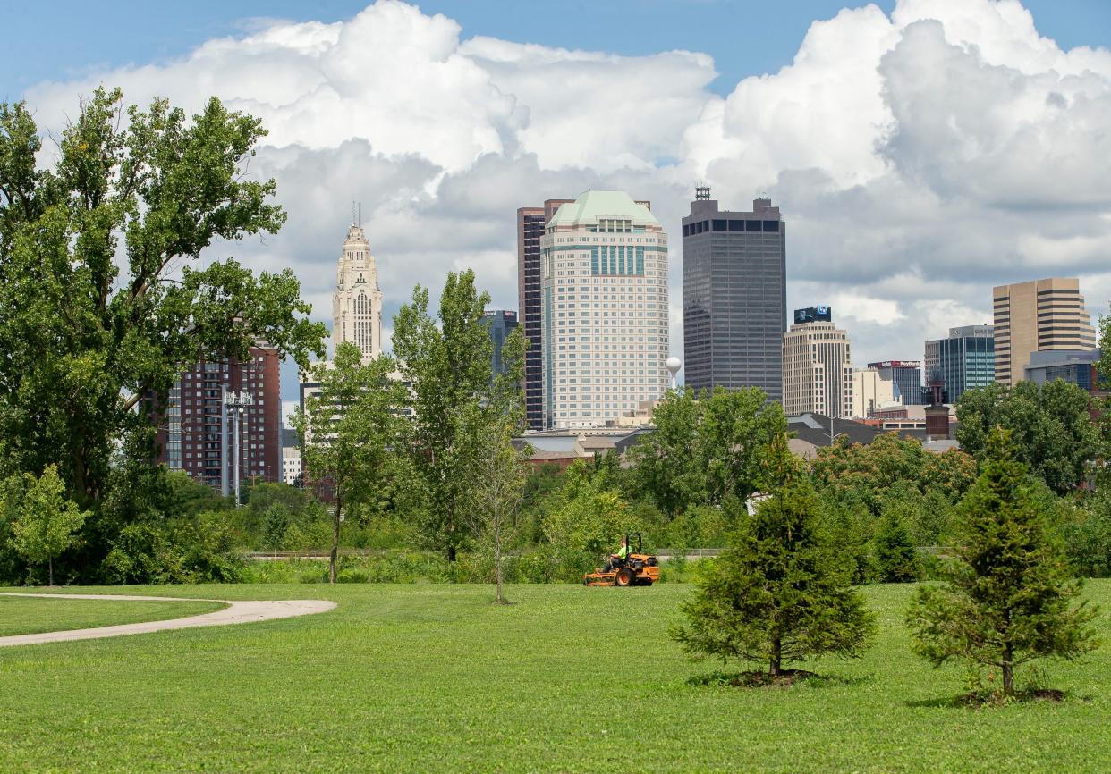 A groundskeeper mows a grassy area near the site for the new Scioto Audubon Dog Park in Columbus on Wednesday, Aug. 18, 2021. The dog park will move closer to the park office on the south side of the park to make room for ODOT to use the land of the current dog park for the I-70 project. 