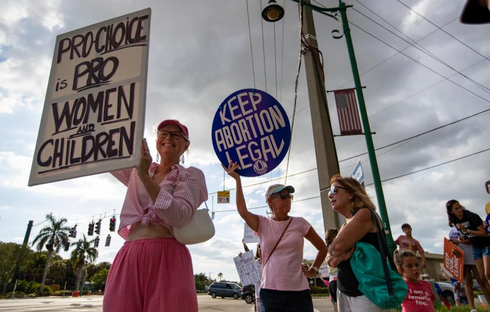 Naples resident and choice advocate Kate Tardif, left, holds a sign at the intersection of US 41 and Airport-Pulling Rd. S. Tuesday, May 3, 2022 . About 75 pro choice supporters gathered in front of the Collier County Courthouse and marched to rally in response to the leaked Roe vs. Wade Supreme Court opinion.