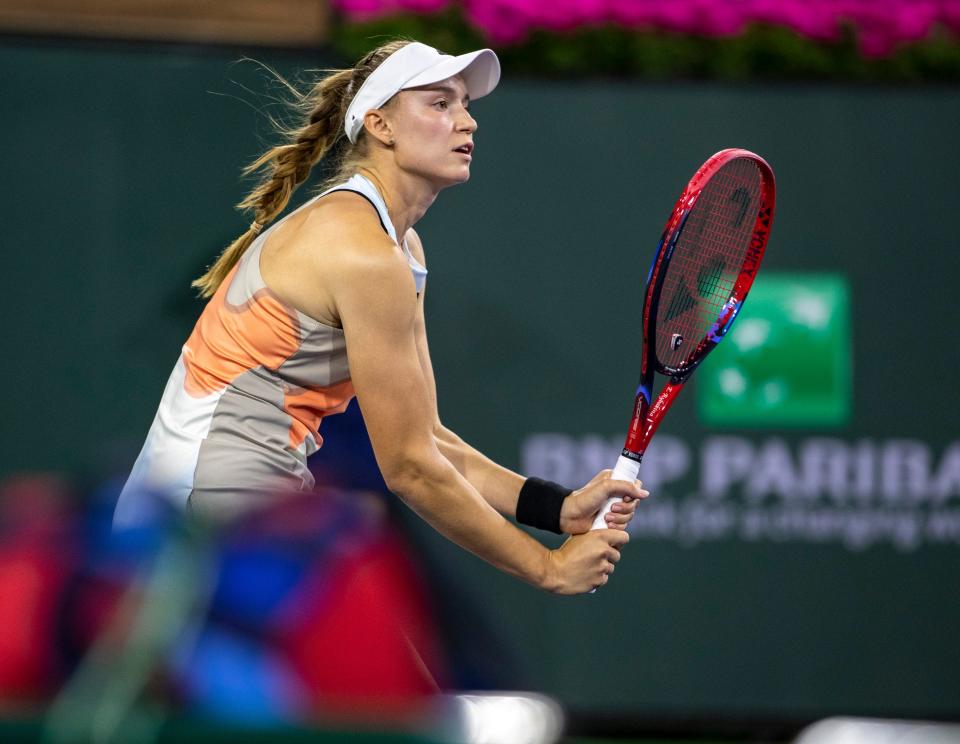 Elena Rybakina of Kazakhstan awaits a serve from Iga Swiatek of Poland during their semifinal match at the BNP Paribas Open at the Indian Wells Tennis Garden in Indian Wells, Calif., Friday, March 17, 2023. 