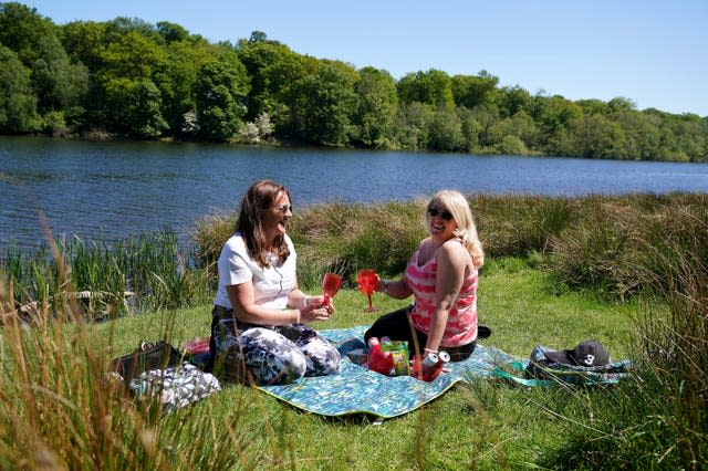 People enjoy the sunshine in Tatton Park