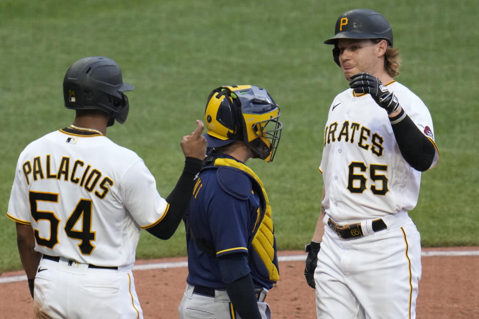 Pittsburgh Pirates' Jack Suwinski (65) is greeted by Josh Palacios (54) after hitting a two-run home run off Milwaukee Brewers relief pitcher Clayton Andrews during the eighth inning of a baseball game in Pittsburgh, Saturday, July 1, 2023. (AP Photo/Gene J. Puskar)