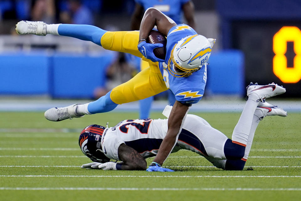 Los Angeles Chargers tight end Donald Parham Jr., top, is tackled by Denver Broncos safety Kareem Jackson during the first half of an NFL football game, Monday, Oct. 17, 2022, in Inglewood, Calif. (AP Photo/Marcio Jose Sanchez)