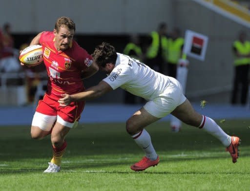 Stade Toulousain Yannick Jauzion (R) tackles Perpignan's Hume Gavin (L) during the French Top 14 Rugby Union match at the Olympic Stadium Lluis Companys in Barcelona. Perpignan put their poor start to the Top 14 campaign behind them as they humbled champions Toulouse 34-20, grabbing an offensive bonus point in the process