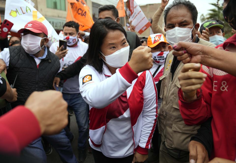 Presidential candidate Keiko Fujimori, of the Popular Force party, fist bumps a supporter during a rally in the Puente Piedra neighborhood, on the outskirts of Lima, Peru, Tuesday, June 1, 2021. Fujimori will face rival candidate Pedro Castillo in the June 6 presidential run-off election. (AP Photo/Martin Mejia)