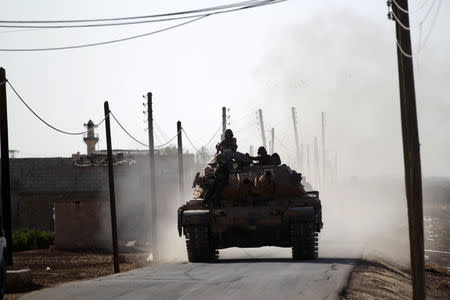 A Turkish tank drives near Guzhe village, northern Aleppo countryside, Syria October 17, 2016. REUTERS/Khalil Ashawi