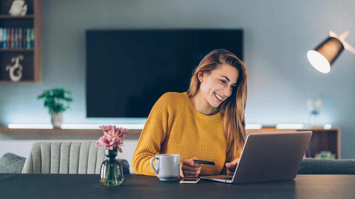 Beautiful woman shopping online at home.