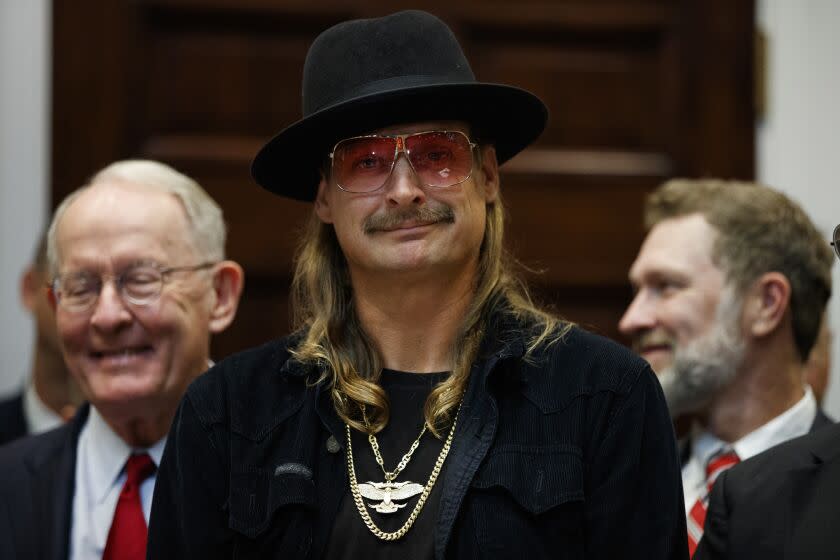 Musician Kid Rock listens as President Donald Trump speaks during a signing ceremony