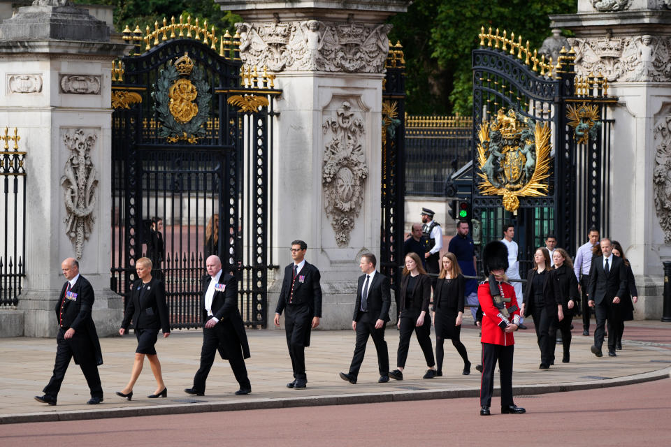 <p>Buckingham Palace household staff pay their respects outside during the ceremonial procession. (PA)</p> 