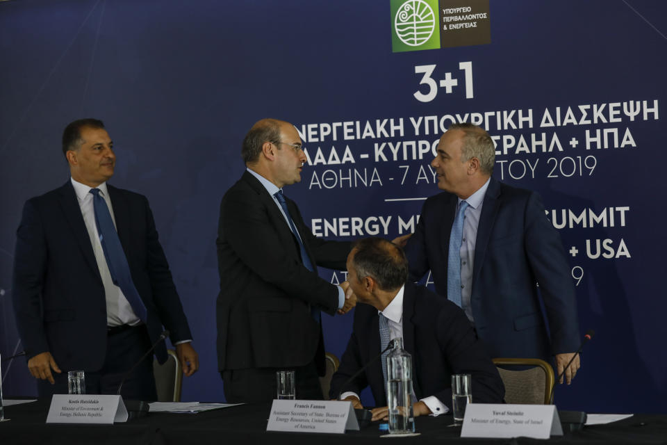 Greek Minister of Environment and Energy Kostas Hatzidakis, second left, shakes hands with Israel's Energy Minister Yuval Steinitz, right, as U.S. Assistant Secretary of State of Energy Francis Fannon, second right, and Cyprus' Energy Minister Georgios Lakkotrypis , left, look on during a summit in Athens, on Wednesday, Aug. 7, 2019. Ministers of Greece , Cyprus Israel and US participated Wednesday in the first Energy Ministerial Summit. (AP Photo/Petros Giannakouris)