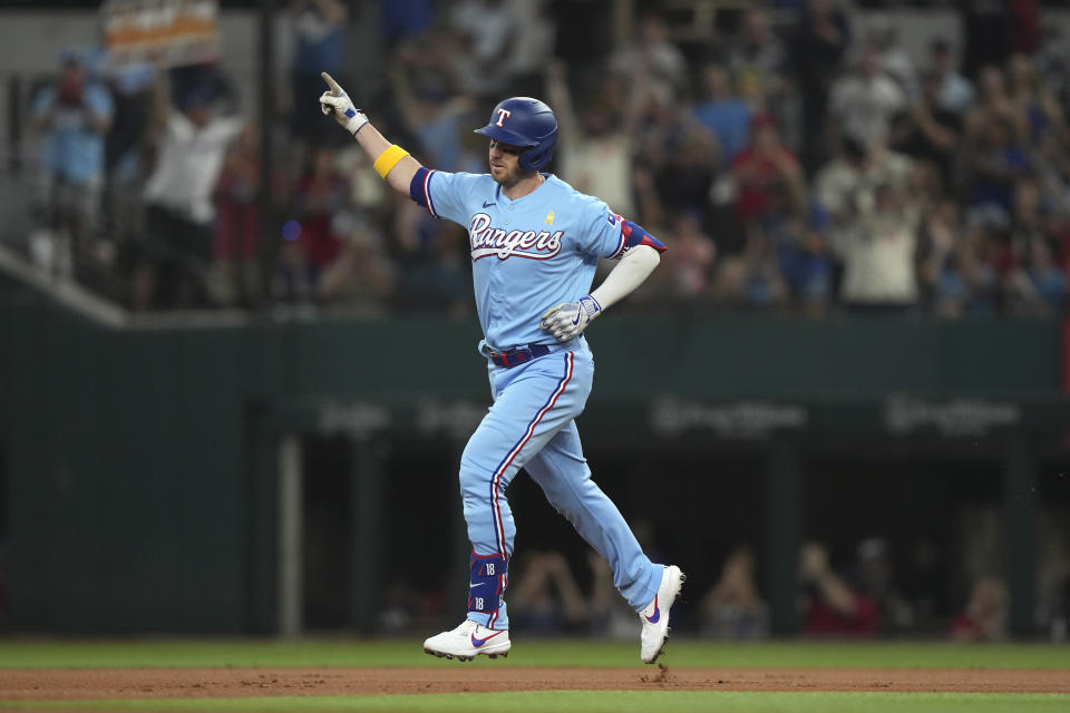 Texas Rangers' Mitch Garver runs the bases after hitting a home run that also scored teammates Corey Seager and Nathaniel Lowe during the first inning of a baseball game in Arlington, Texas, Sunday, Sept. 3, 2023. (AP Photo/LM Otero)