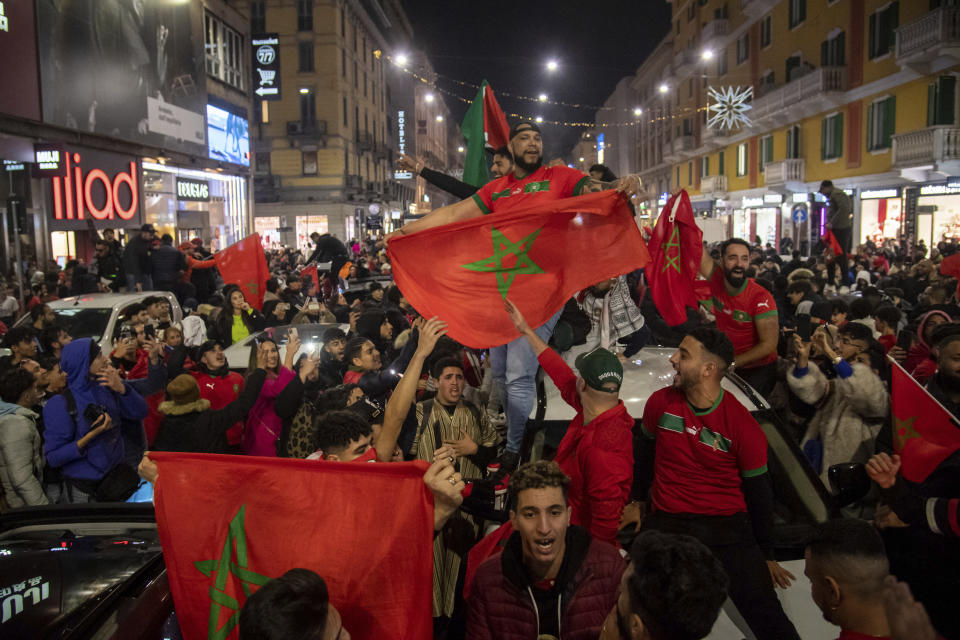 Morocco fans celebrate in Milan, Italy, after their victory against Spain in the World Cup round of 16 soccer match between Morocco and Spain, Tuesday, Dec. 6, 2022. (Claudio Furlan/Lapresse via AP)