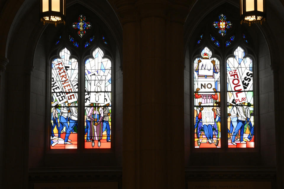 Light shines through new stained-glass windows with a theme of racial justice during an unveiling and dedication ceremony at the Washington National Cathedral for the windows on Saturday, Sept. 23, 2023, in Washington. The windows fill the space that had once held windows honoring Confederate Gens. Robert E. Lee and Stonewall Jackson. The new windows, titled “Now and Forever," are based on a design by artist Kerry James Marshall. Stained glass artisan Andrew Goldkuhle crafted the windows based on that design. (AP Photo/Nick Wass)