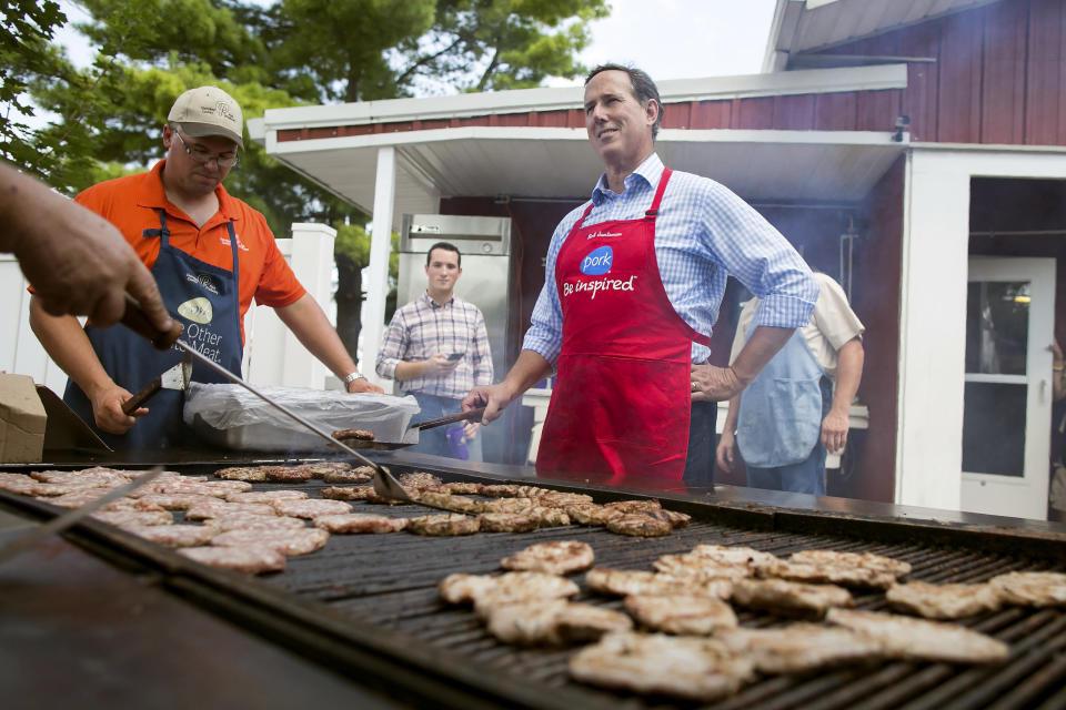 <p>Former Sen.&nbsp;Rick Santorum (R-Pa.) manages the grill as he cooks pork chops.</p>