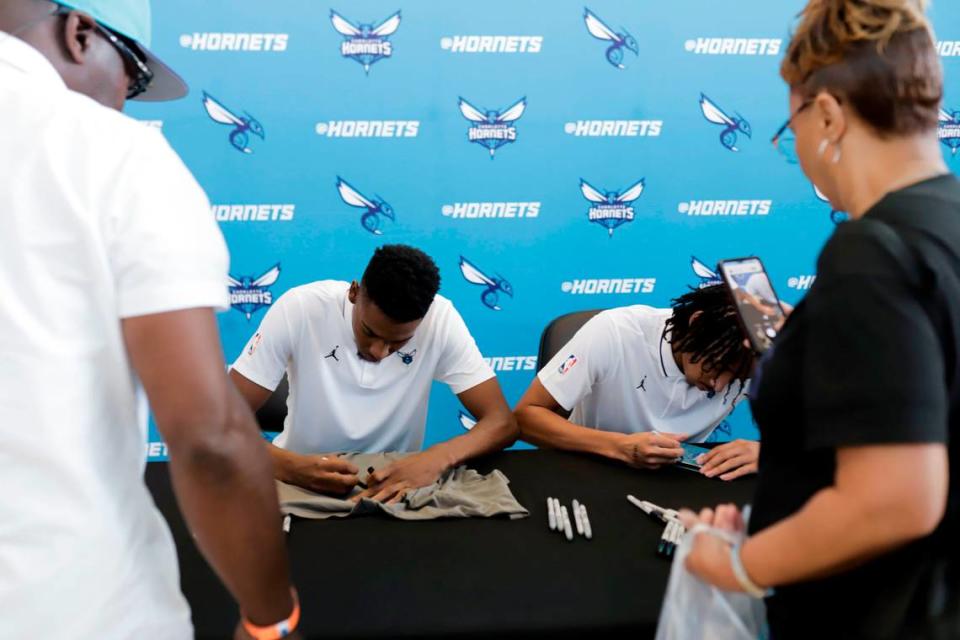 Newly Drafted players Brandon Miller, left, and Amari Bailey sign autographs for fans after a press conference with the players at Spectrum Center on Friday, June 23, 2023. Sean McInnis/smcinnis@charlotteobserver.com