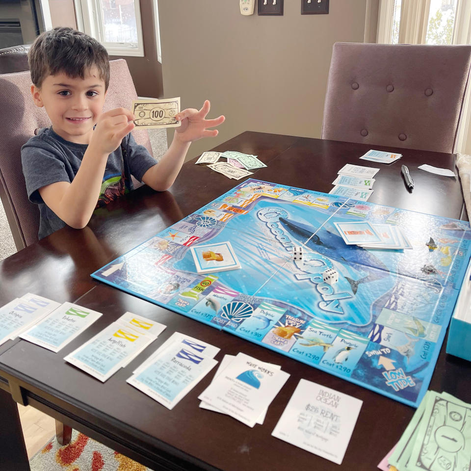 Mason Stonehouse playing with Monopoly money. (Courtesy Keith Stonehouse)