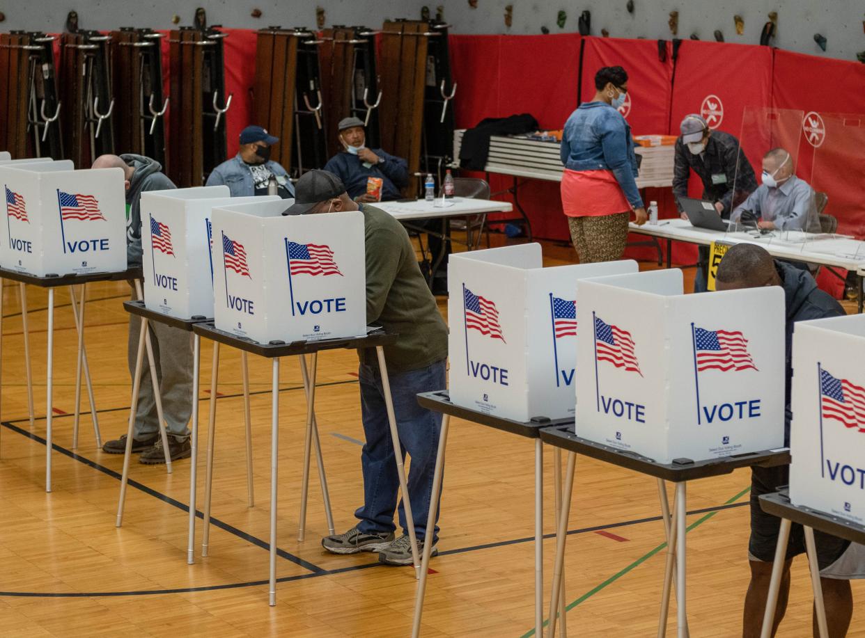 Residents cast their votes on November 3, 2020, at Eisenhower Elementary School in Flint, Michigan. - The US is voting Tuesday in an election amounting to a referendum on Donald Trump's uniquely brash and bruising presidency, which Democratic opponent and frontrunner Joe Biden urged Americans to end to restore "our democracy." (Photo by Seth Herald / AFP) (Photo by SETH HERALD/AFP via Getty Images)