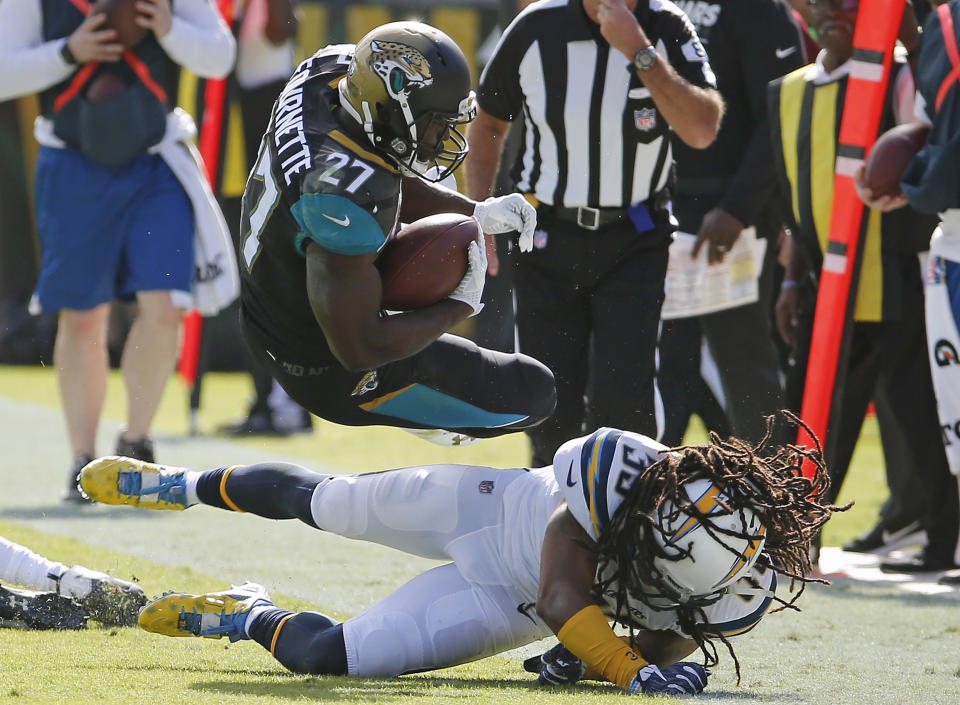 <p>Los Angeles Chargers safety Tre Boston (33) upends Jacksonville Jaguars running back Leonard Fournette (27) after a short gain during the first half of an NFL football game, Sunday, Nov. 12, 2017, in Jacksonville, Fla. (AP Photo/Stephen B. Morton) </p>