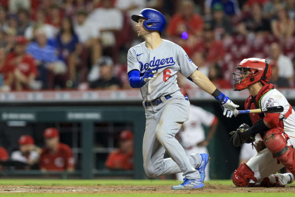 Los Angeles Dodgers' Trea Turner watches his sacrifice fly during the eighth inning of the team's baseball game against the Cincinnati Reds in Cincinnati, Wednesday, June 22, 2022. The Dodgers won 8-4. (AP Photo/Aaron Doster)