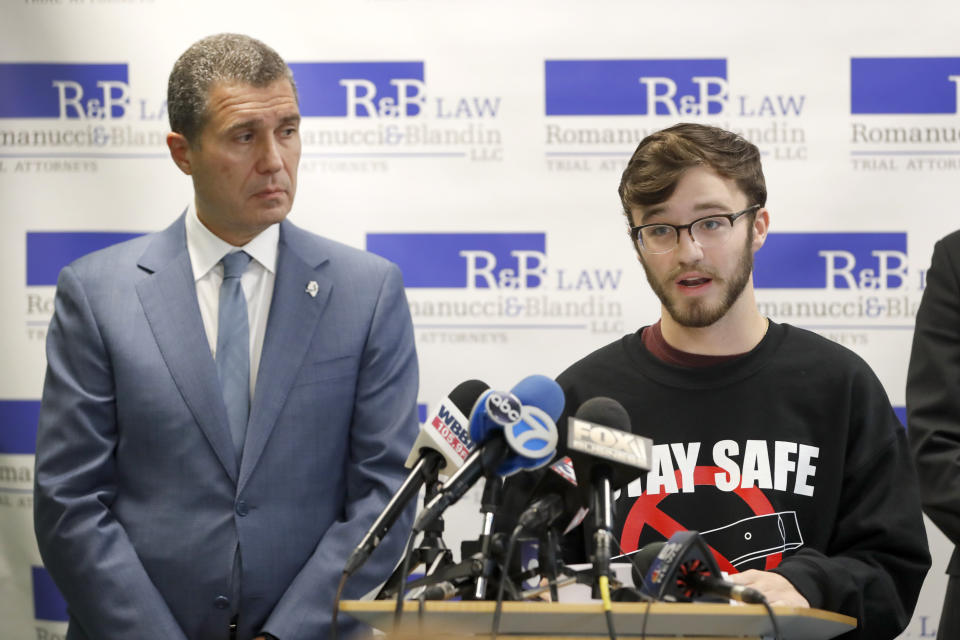 Adam Hergenreder, right, responds to a question as Attorney Antonio Romanucci, listens after Romanucci announced the filing of a civil lawsuit against e-cigarette maker Juul, on behalf of Hergenreder, during a news conference Friday, Sept. 13, 2019, in Chicago. The lawsuit filed Friday in Lake County, Illinois, Circuit Court alleges Juul Labs, Inc., deliberately targeted young people through Instagram and other sites to suggest vaping can boost their social status. It also says Juul doesn't fully disclose their products contain dangerous chemicals. (AP Photo/Charles Rex Arbogast)