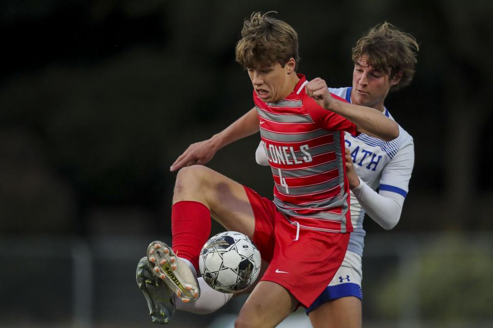 Dixie Heights' Bennett Gerak (4) battles for the ball against Covington Catholic's Mac Tierney (7) during last week's Ninth Region tournament.