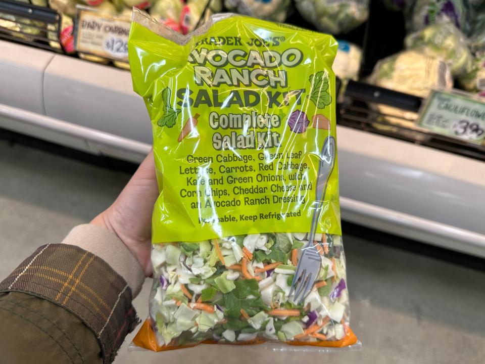 hand holding up an avocado ranch salad kit at trader joe's