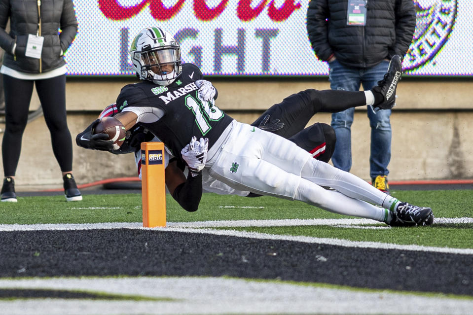 Marshall's Chuck Montgomery (10) stretches out for a touchdown against Arkansas State during an NCAA college football game Saturday, Nov. 25, 2023, in Huntington, W.Va. (Sholten Singer/The Herald-Dispatch via AP)