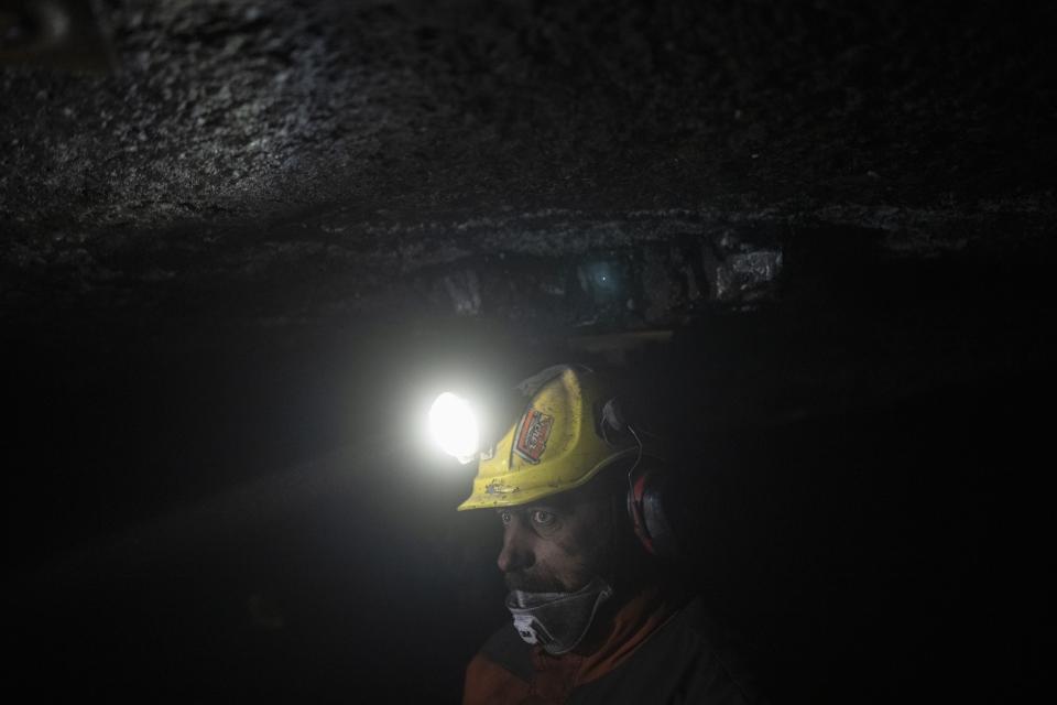 Coal miner Jonny Sandvoll works at the bottom of the Gruve 7 coal mine in Adventdalen, Norway, Monday, Jan. 9, 2023. Gruve 7, the last Norwegian mine in one of the fastest warming places on earth, was scheduled to shut down this year and only got a reprieve through 2025 because of the energy crisis driven by the war in Ukraine. Sandvoll said he wished people understood more about coal and its uses before deciding to close the mine. (AP Photo/Daniel Cole)