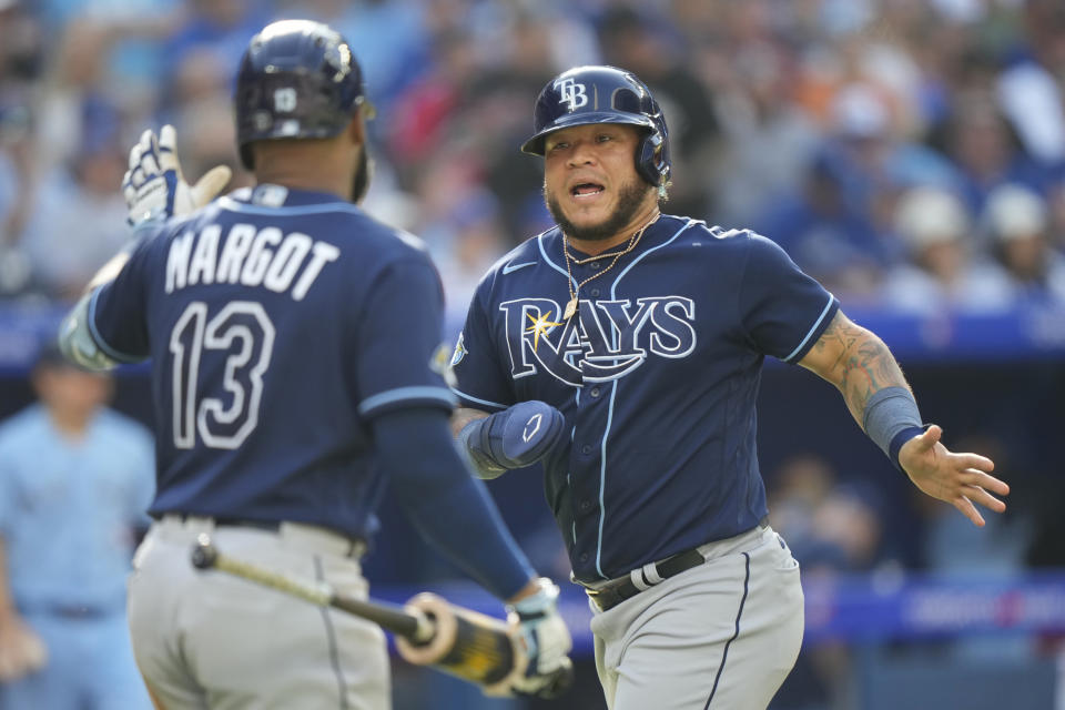 Tampa Bay Rays' Harold Ramirez celebrates with Manuel Margot (13) after scoring during the third inning of a baseball game against the Tampa Bay Rays in Toronto, Saturday, Sept. 30, 2023. (Frank Gunn/The Canadian Press via AP)