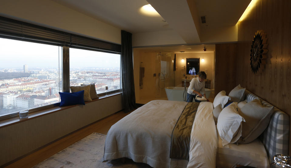 In this picture taken March 6, 2013, an employee prepares a hotel room at the Zizkov television tower in Prague, Czech Republic. Seventy-three meters above the ground, the six-star luxurious room is available for 1,000 euro (US $1,305) per night since its opening on Feb 13. (AP Photo/Petr David Josek)