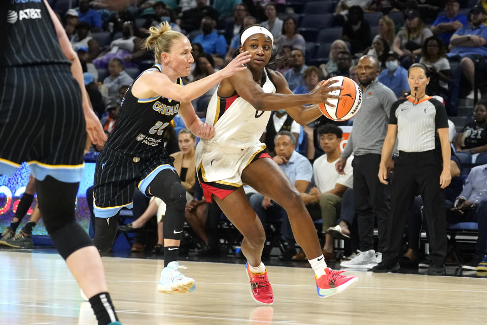 Las Vegas Aces' Jackie Young (0) drives to the basket past Chicago Sky's Courtney Vandersloot during the first half of the WNBA Commissioner's Cup basketball game Tuesday, July 26, 2022, in Chicago. (AP Photo/Charles Rex Arbogast)