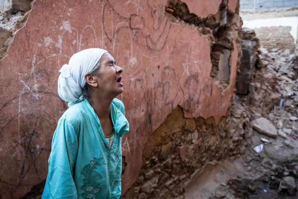 A woman reacts standing in front of her earthquake-damaged house in the old city in Marrakesh. (Pic: Fadel Senna/AFP via Getty Images)