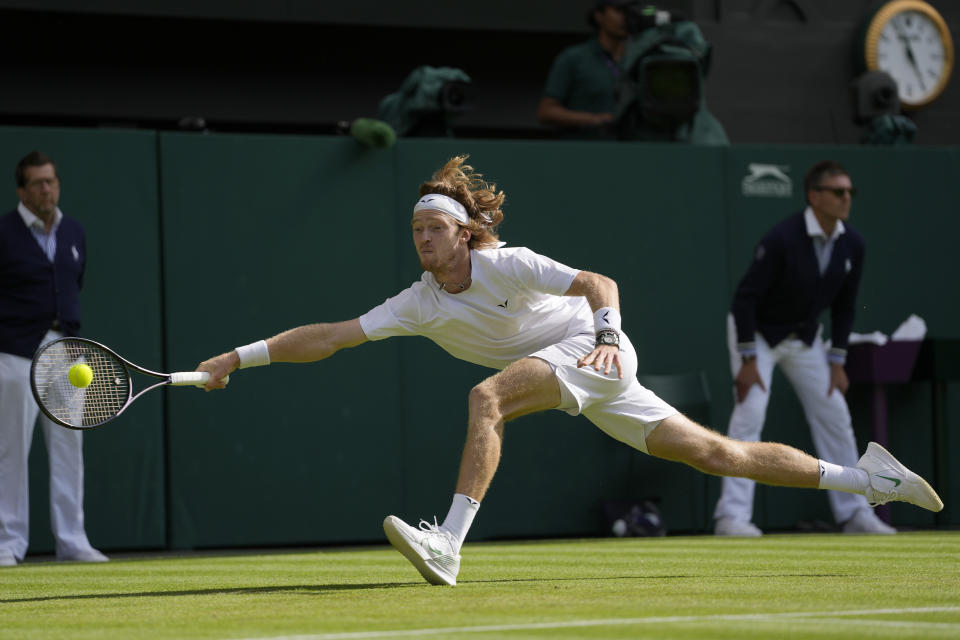 Russia's Andrey Rublev returns to Kazakhstan's Alexander Bublik in a men's singles match on day seven of the Wimbledon tennis championships in London, Sunday, July 9, 2023. (AP Photo/Kirsty Wigglesworth)