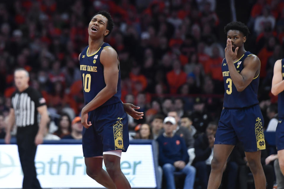 Notre Dame guard Marcus Hammond, left, reacts during the first half of the team's NCAA college basketball game against Syracuse in Syracuse, N.Y., Saturday, Jan. 14, 2023. (AP Photo/Adrian Kraus)