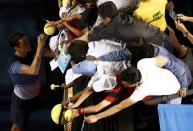 Canada's Milos Raonic signs autographs after winning his quarter-final match against France's Gael Monfils at the Australian Open tennis tournament at Melbourne Park, Australia, January 27, 2016. REUTERS/Jason Reed