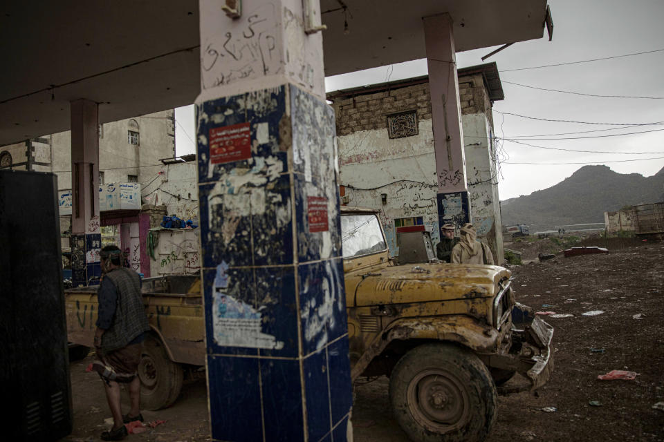 In this Aug. 4, 2019 photo, Yemeni men stop at a gas station in Dhale province, an active frontline between militiamen backed by the Saudi-led coalition and Houthi rebels, where African migrants cross to continue their journey in Yemen. According to the U.N.'s International Organization for Migration, 150,000 arrived in Yemen from the Horn of Africa in 2018, a 50% jump from the year before. The number in 2019 was similar. They dream of reaching Saudi Arabia, and earning enough to escape poverty by working as laborers, housekeepers, servants, construction workers and drivers. (AP Photo/Nariman El-Mofty)