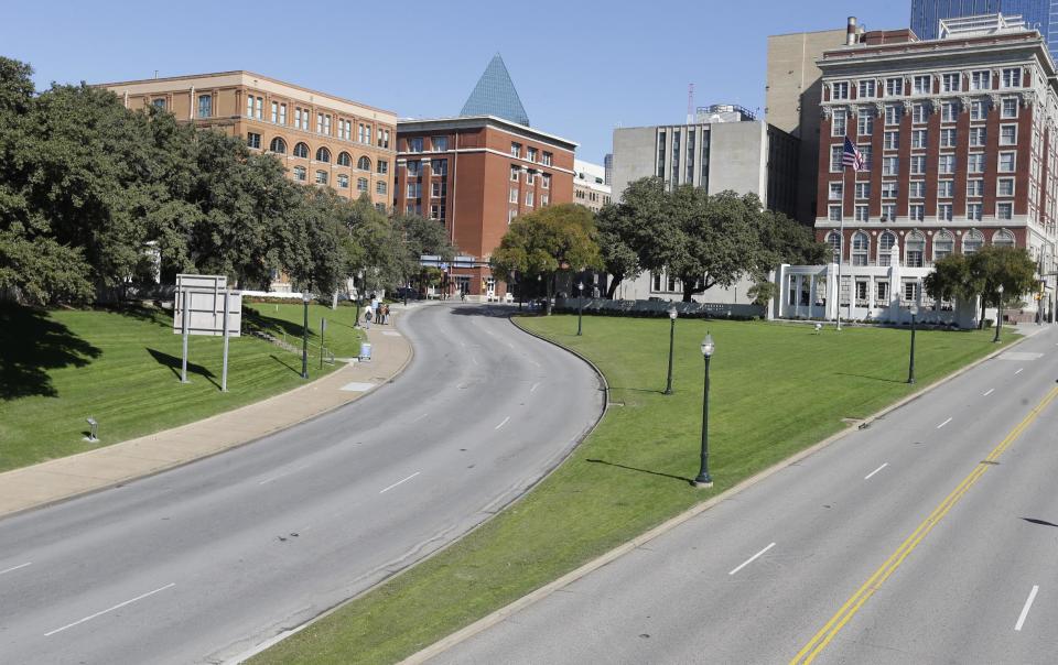 The former Texas School Book Depository building, left, now known as the Sixth Floor Museum overlooks Dealey Plaza in Dallas, Tuesday, Nov. 12, 2013, where Lee Harvery Oswald fired from the building killing President John F. Kennedy on Nov. 22, 1963. (AP Photo/LM Otero)