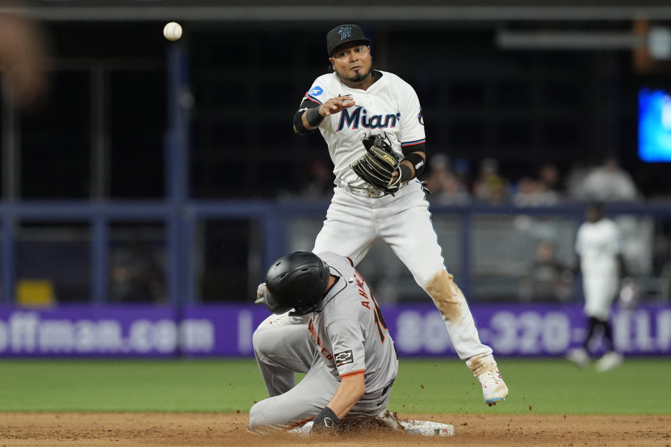 Miami Marlins second baseman Luis Arraez (3) attempts to complete the double play as San Francisco Giants' Nick Ahmed (16) is forced out during the fifth inning of a baseball game, Tuesday, April 16, 2024, in Miami. (AP Photo/Marta Lavandier)