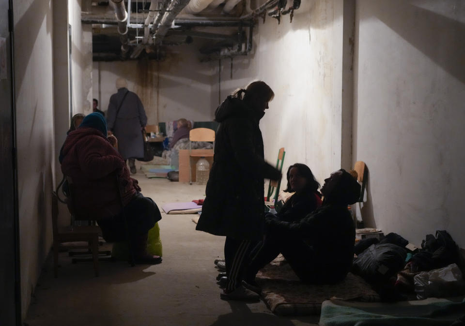 People hide from the Russian artillery shelling in a school basement in the village of Horenka close to Kyiv, Ukraine, Sunday, March 6, 2022. On Day 11 of Russia's war on Ukraine, Russian troops shelled encircled cities, and it appeared that a second attempt to evacuate civilians from the besieged port city of Mariupol had failed due to continued violence. (AP Photo/Efrem Lukatsky)