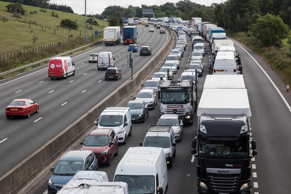 Traffic is queued on the M25 after climate activists from Insulate Britain block a slip road as part of a new campaign intended to push the UK government to make significant legislative change to start lowering emissions on 13th September 2021 in Godstone, United Kingdom. The activists, who wrote to Prime Minister Boris Johnson on 13th August, are demanding that the government immediately promises both to fully fund and ensure the insulation of all social housing in Britain by 2025 and to produce within four months a legally binding national plan to fully fund and ensure the full low-energy and low-carbon whole-house retrofit, with no externalised costs, of all homes in Britain by 2030 as part of a just transition to full decarbonisation of all parts of society and the economy. (photo by Mark Kerrison/In Pictures via Getty Images)