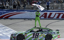 Kyle Busch celebrates after winning the NASCAR Cup Series auto race at Auto Club Speedway in Fontana, Calif., Sunday, March 17, 2019. (James Quigg/The Daily Press via AP)