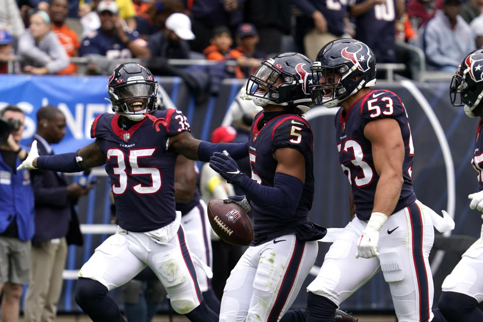 Houston Texans safety Jalen Pitre (5) celebrates with Blake Cashman (53) and Grayland Arnold (35) after intercepting a pass against the Chicago Bears during the second half of an NFL football game Sunday, Sept. 25, 2022, in Chicago. (AP Photo/Nam Y. Huh)