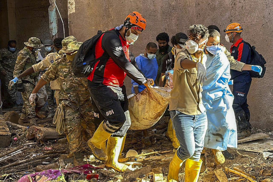 In this photo provided by Turkey's IHH humanitarian aid group, rescuers retrieve the body of a flooding victim in Derna, Libya, Wednesday, Sept.13, 2023. (IHH via AP)