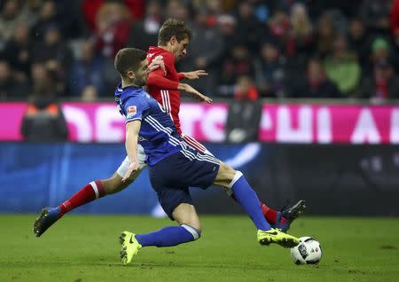 Football Soccer - Bayern Munich v FC Schalke 04 - German Bundesliga - Allianz-Arena, Munich, Germany - 04/02/17 - Thomas Muller of Bayern Munich in action with Matija Nastasic of Schalke. REUTERS/Michael Dalder