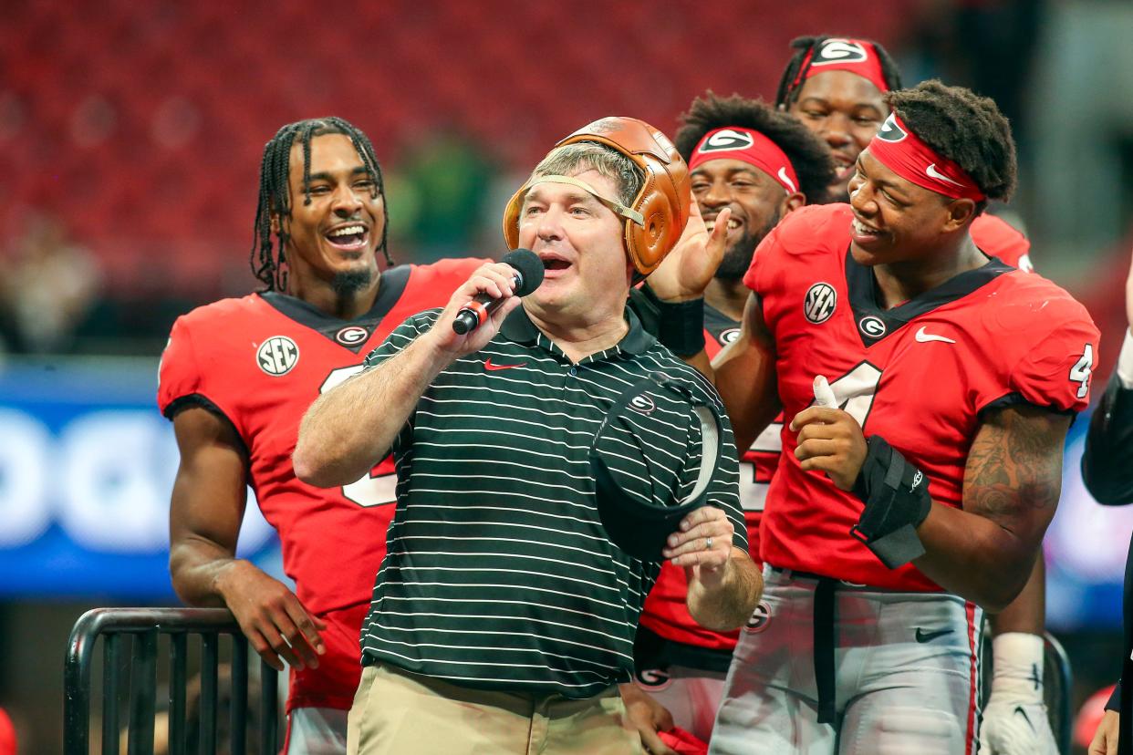 Sep 3, 2022; Atlanta, Georgia; Georgia Bulldogs linebacker Nolan Smith (4) puts the Old Leather Helmet on head coach Kirby Smart after a victory against the Oregon Ducks at Mercedes-Benz Stadium. Brett Davis-USA TODAY Sports