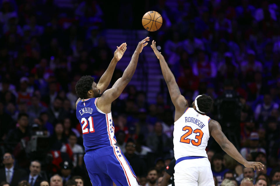 Mitchell Robinson reacts to Sixers’ Joel Embiid grabbing his leg ...