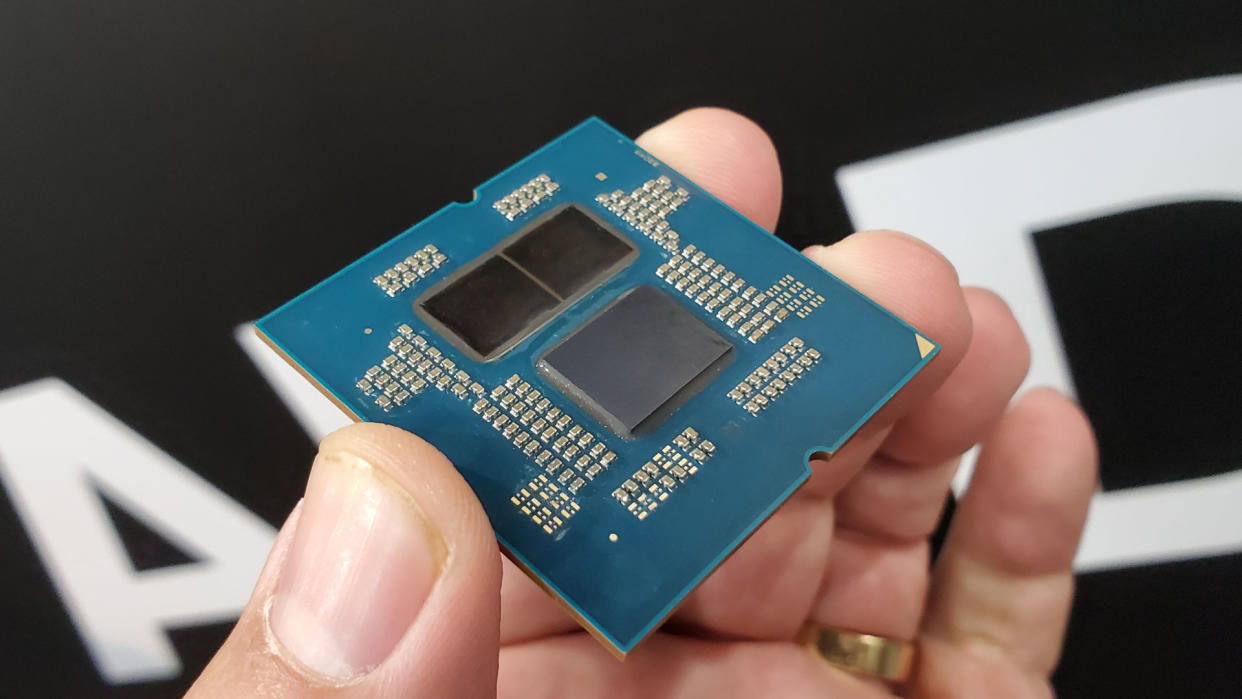  A delidded AMD Ryzen 9000 series processor held in a hand, showing the two CCD and one IOD chiplets. 