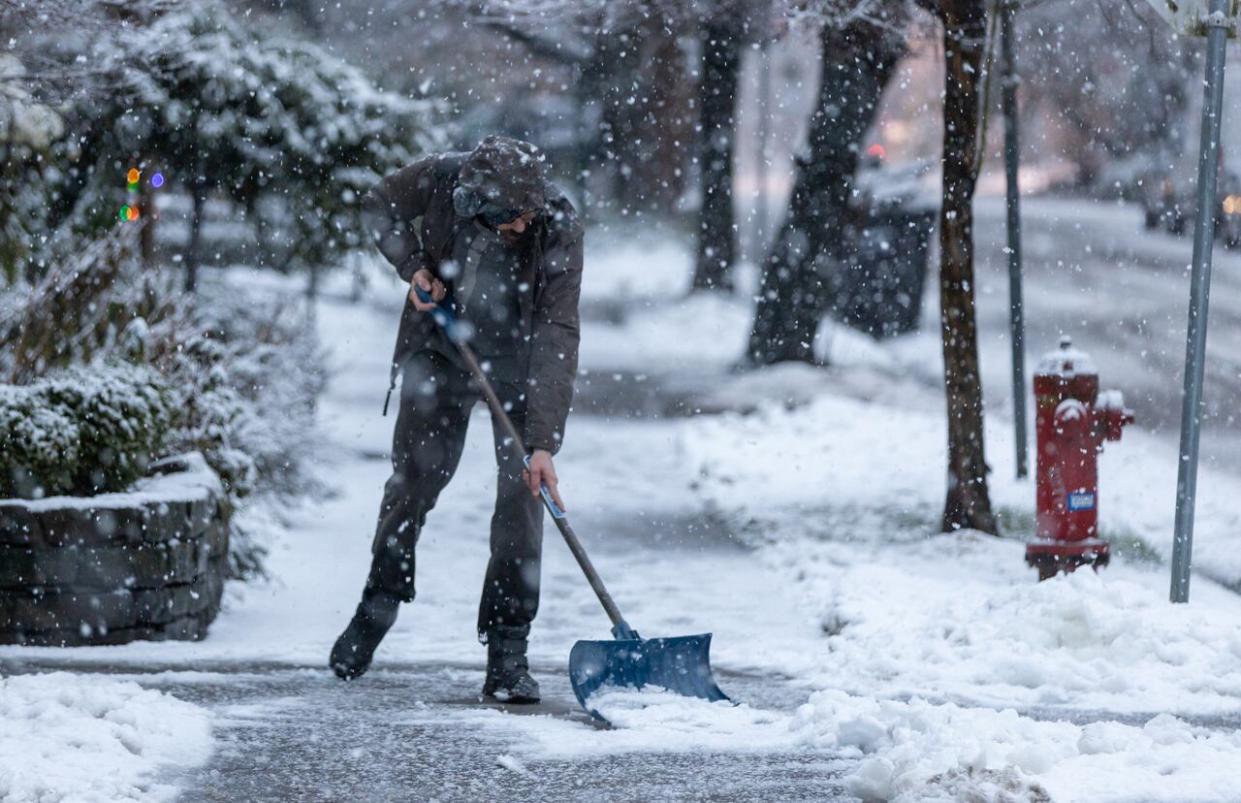 A person shovels a sidewalk in Vancouver's West End neighbourhood in January 2020. Courts have concluded homeowners cannot be found liable for injuries suffered as a result of them doing a poor job of clearing sidewalks in front of their houses.  (Andrew Lee/CBC - image credit)