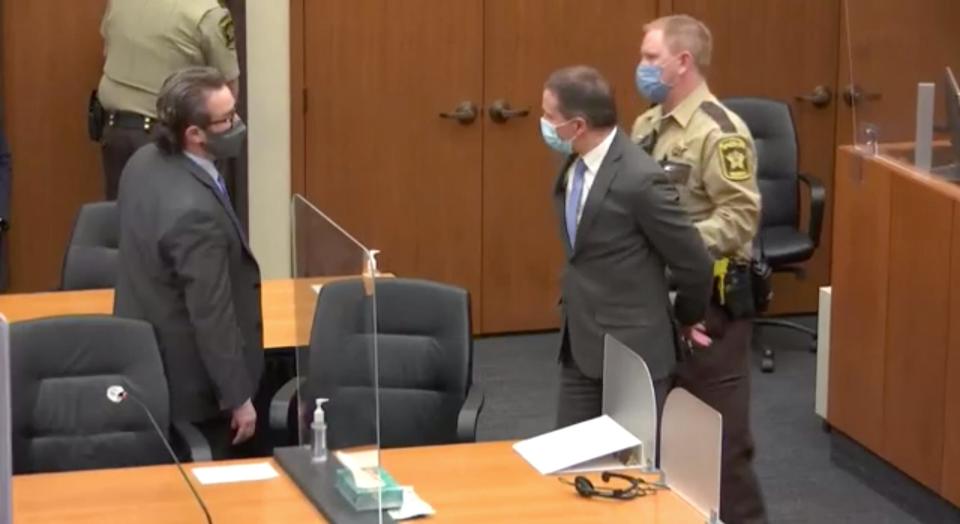 Former police officer Derek Chauvin is led out of the courtroom in handcuffs after a guilty verdict is read during his trial in the death of George Floyd at the courthouse in Minneapolis on Tuesday.