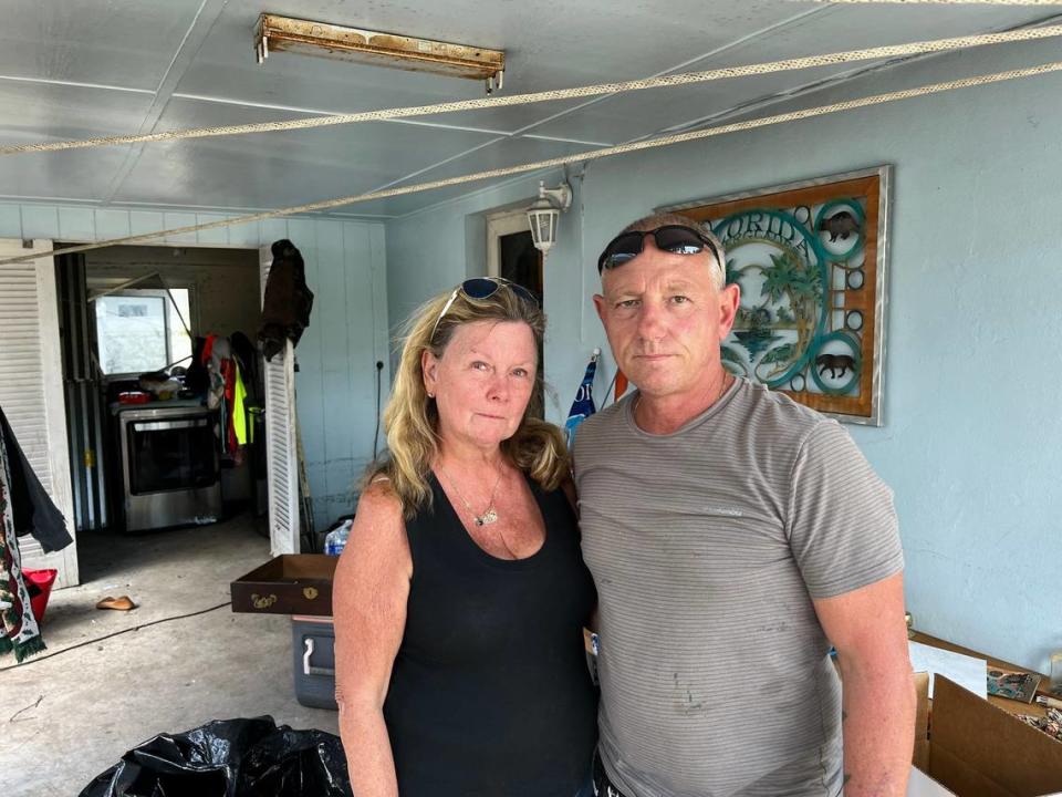 Anne McDougall, 64, and Marvin Kitrell, pose in front of McDougall’s flooded home in Fort Lauderdale. Kitrell’s home saw less flooding so he’s been helping his neighbors, like McDougall, clean up. Alex Harris/aharris@miamiherald.com
