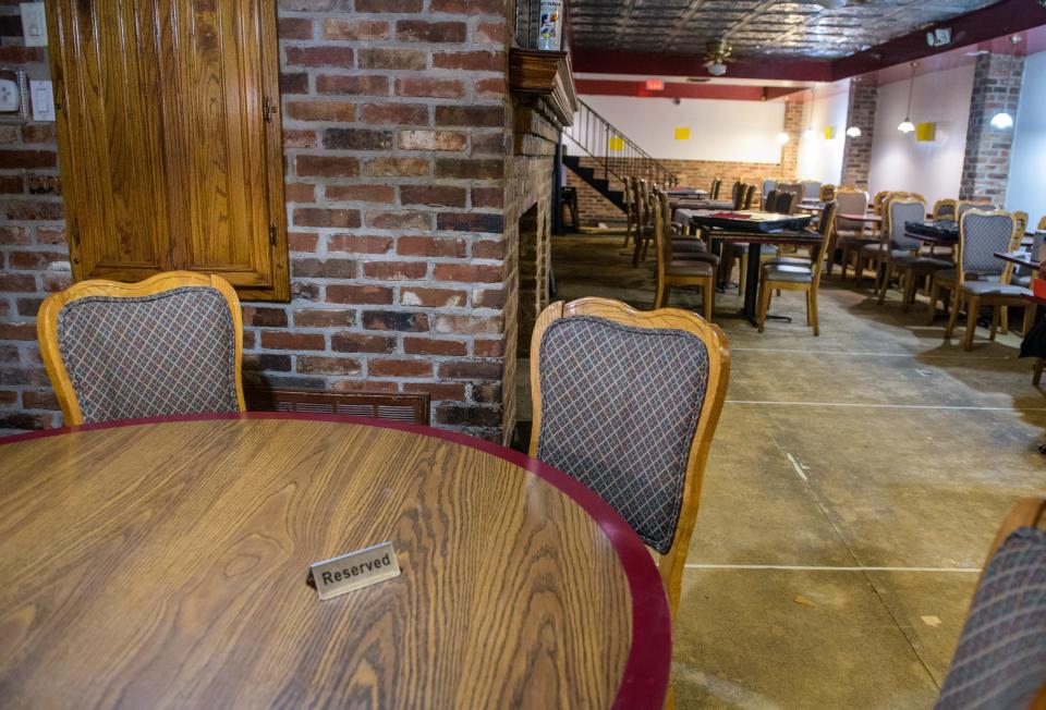 A "Reserved" sign sits on a large round table next to the fireplace in the former Richard's on Main in downtown Peoria. The space will soon reopen as Richard's Under Main.